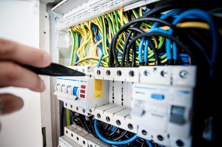 electrician fixing breaker panel